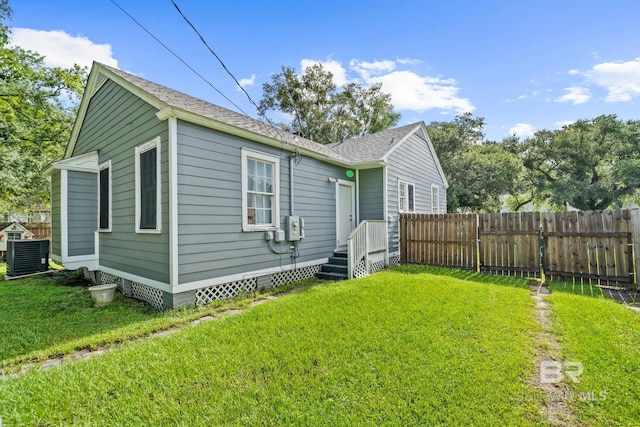 view of front of property featuring central AC and a front lawn