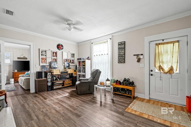 entryway with crown molding, wood-type flooring, and ceiling fan