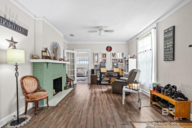 sitting room with hardwood / wood-style flooring, ornamental molding, and plenty of natural light