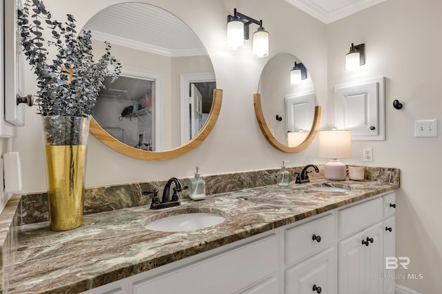 bathroom featuring ornamental molding and vanity