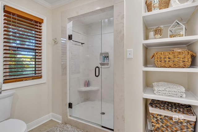 bathroom with crown molding, an enclosed shower, and toilet