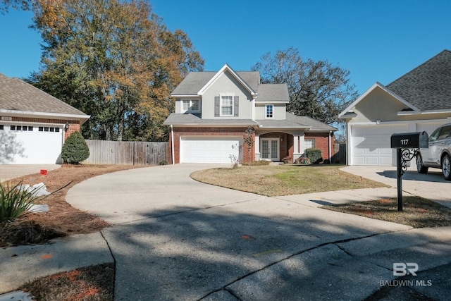 view of property with a garage and a front yard