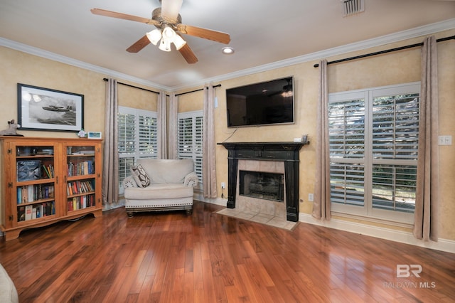 unfurnished living room with crown molding, hardwood / wood-style floors, a fireplace, and ceiling fan