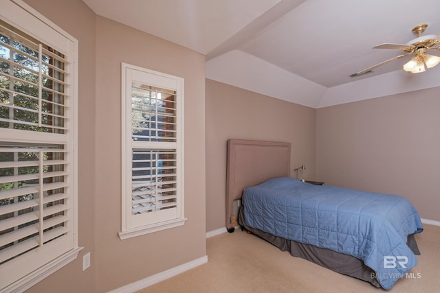 bedroom with ceiling fan, light colored carpet, multiple windows, and lofted ceiling