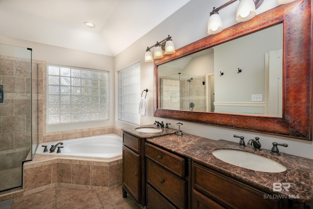 bathroom featuring vanity, vaulted ceiling, and separate shower and tub