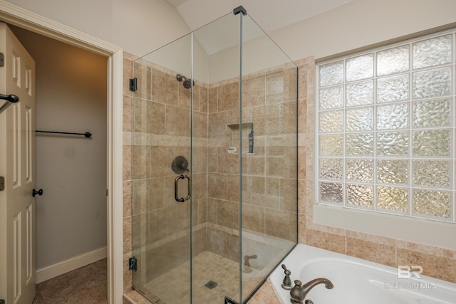 bathroom with shower with separate bathtub