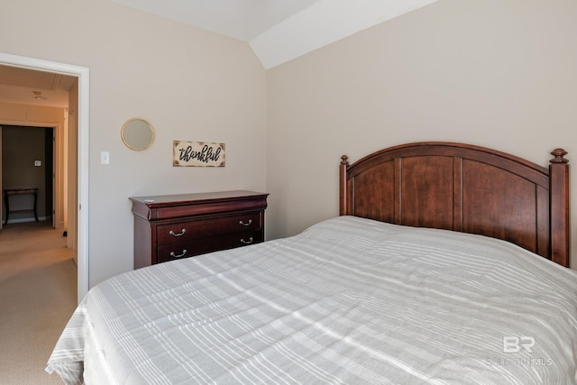 carpeted bedroom featuring lofted ceiling