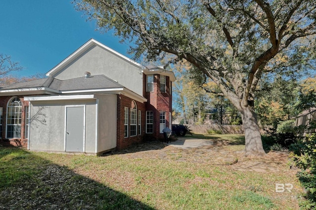 view of property exterior with a lawn