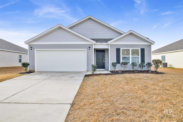 view of front of house featuring a garage and a front lawn