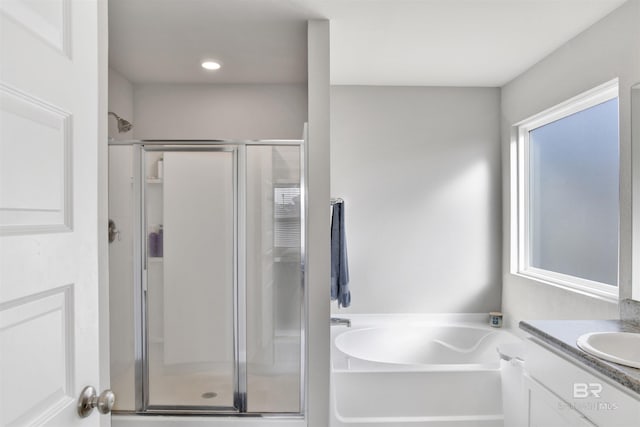 bathroom featuring vanity and plus walk in shower