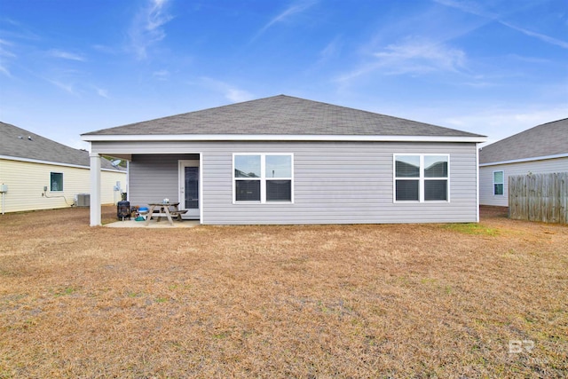 back of house with cooling unit, a yard, and a patio area