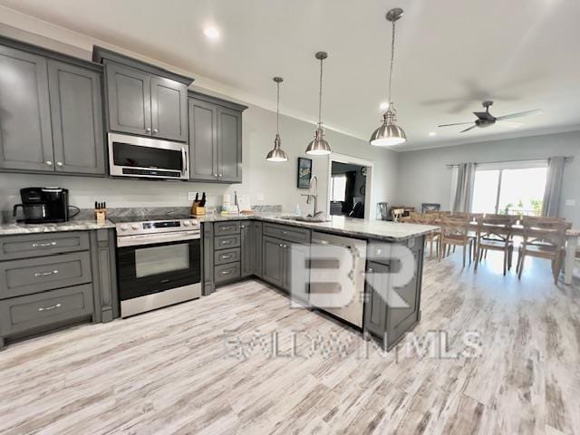 kitchen featuring ceiling fan, hanging light fixtures, kitchen peninsula, gray cabinets, and appliances with stainless steel finishes