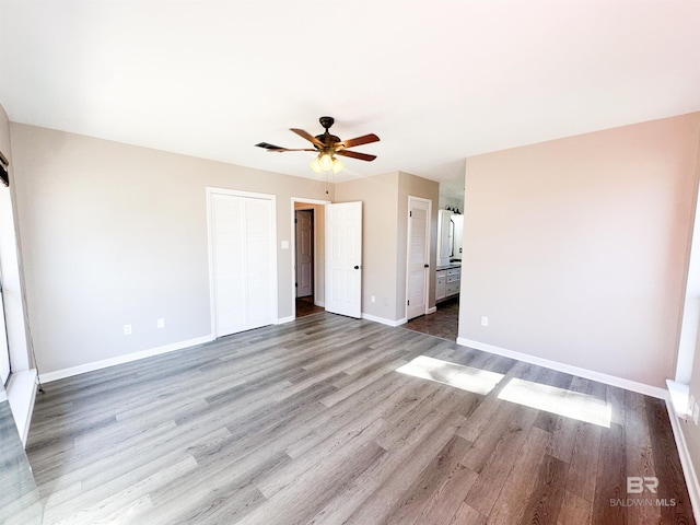 unfurnished bedroom with light wood-style floors, visible vents, baseboards, and ceiling fan