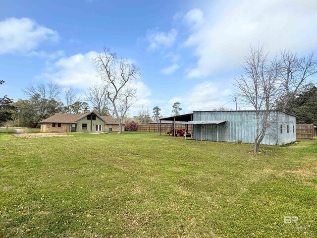 1104 N Pine St, Foley, AL 36535 - view of yard featuring an outbuilding, an outdoor structure, and fence