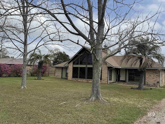 1104 N Pine St, Foley, AL 36535 - exterior space with a front yard, brick siding, and a chimney