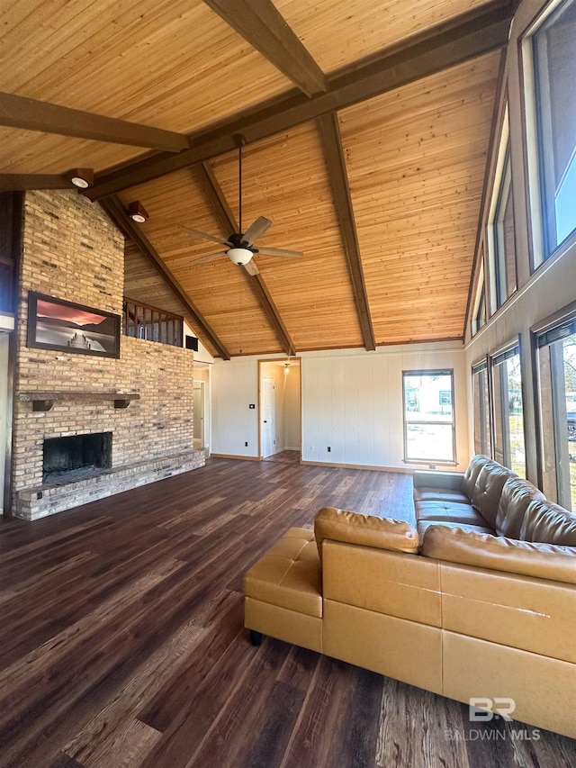 unfurnished living room with a brick fireplace, wooden ceiling, beamed ceiling, and wood finished floors