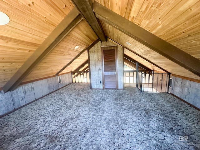 bonus room featuring vaulted ceiling with beams, wooden ceiling, and wooden walls