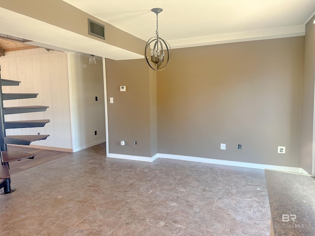 empty room with a chandelier, visible vents, and baseboards