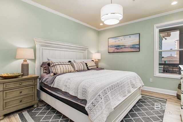 17290 Perdido Key Dr Unit 5B, Pensacola, FL 32507 - bedroom with recessed lighting, crown molding, baseboards, and wood finished floors
