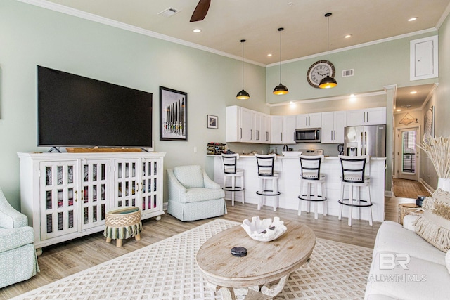 17290 Perdido Key Dr Unit 5B, Pensacola, FL 32507 - living area featuring light wood-type flooring, a high ceiling, visible vents, and crown molding