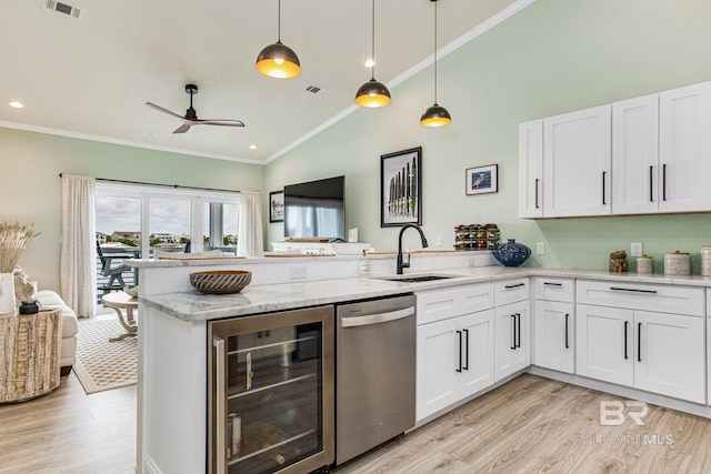 17290 Perdido Key Dr Unit 5B, Pensacola, FL 32507 - kitchen featuring beverage cooler, a peninsula, a sink, stainless steel dishwasher, and crown molding