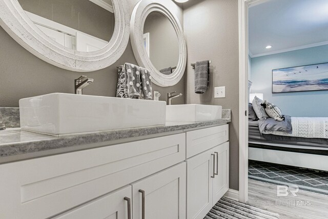 17290 Perdido Key Dr Unit 5B, Pensacola, FL 32507 - ensuite bathroom featuring connected bathroom, recessed lighting, wood finished floors, vanity, and ornamental molding