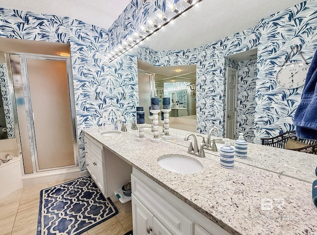 bathroom featuring a sink, a textured ceiling, and wallpapered walls