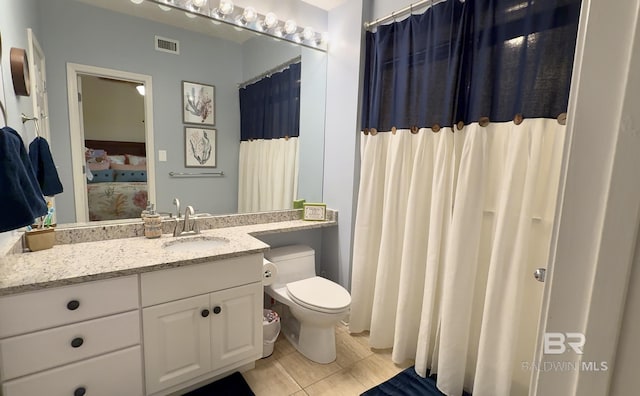 ensuite bathroom featuring tile patterned flooring, vanity, ensuite bath, toilet, and visible vents