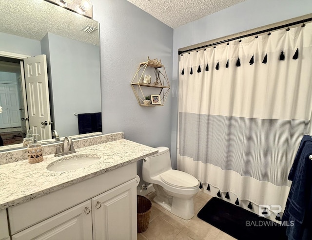 full bathroom featuring tile patterned flooring, vanity, toilet, a textured ceiling, and visible vents