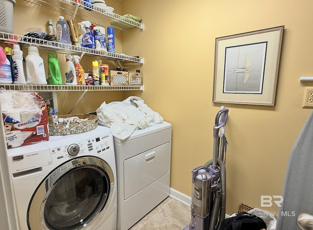 laundry room with baseboards, tile patterned flooring, laundry area, and washer and dryer