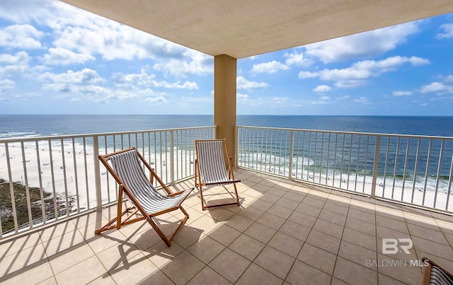 balcony with a beach view and a water view