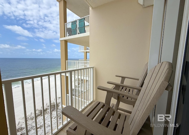 balcony with a beach view and a water view