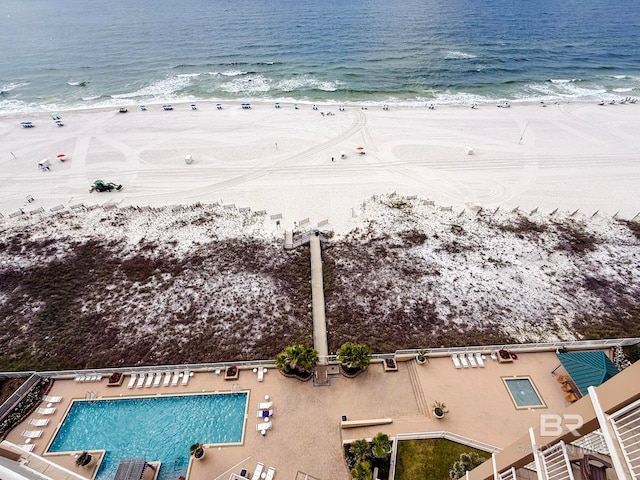 birds eye view of property featuring a beach view and a water view