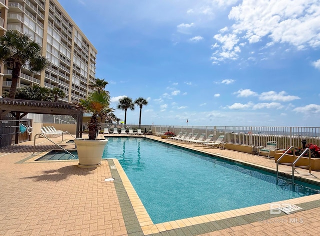 pool featuring a patio area and fence