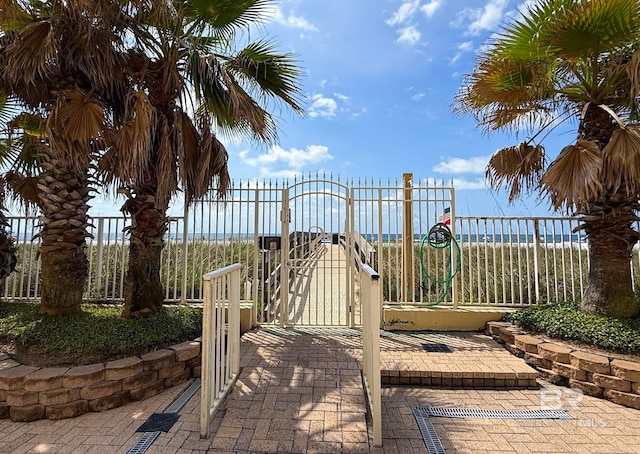 view of playground with a gate and fence
