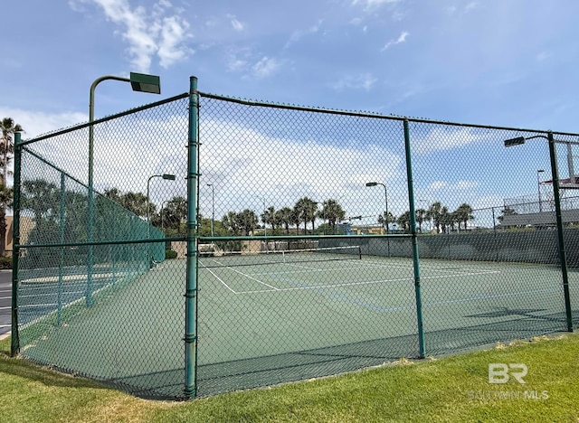view of sport court featuring fence