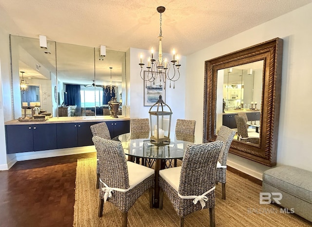 dining room featuring an inviting chandelier, baseboards, a textured ceiling, and visible vents