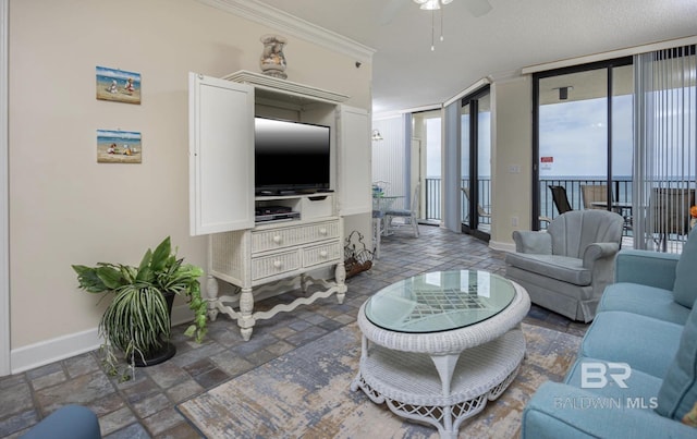 living room featuring crown molding and ceiling fan