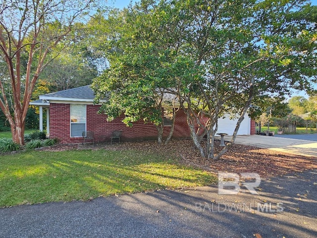 view of front of property with a front yard and a garage