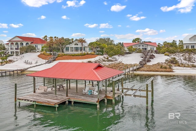 view of dock featuring a residential view, a water view, and boat lift