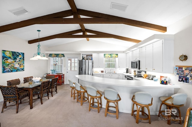 kitchen with visible vents, white cabinetry, stainless steel appliances, and light countertops