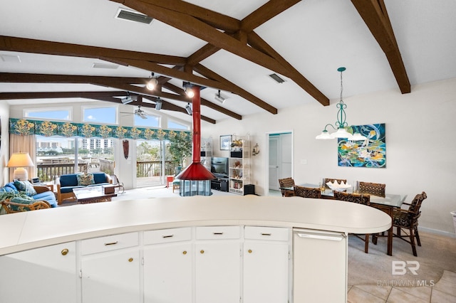 kitchen featuring open floor plan, light countertops, a wood stove, and white cabinetry