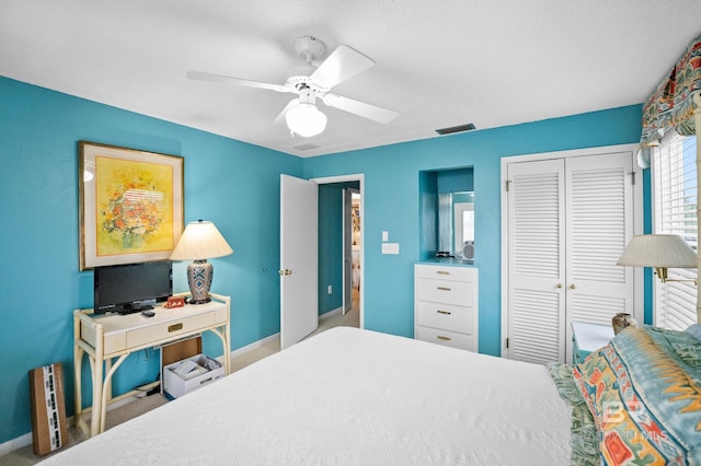 bedroom with a ceiling fan, a closet, visible vents, and baseboards