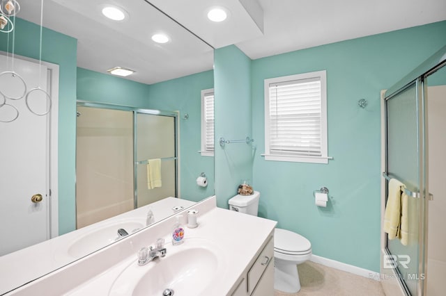 full bath featuring a stall shower, vanity, baseboards, and recessed lighting