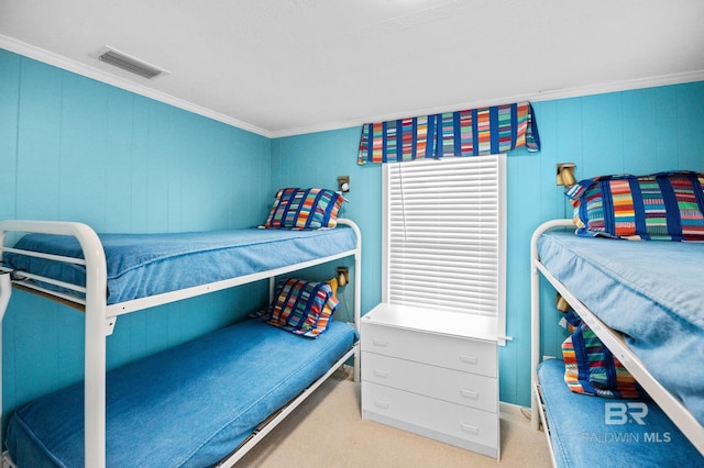 bedroom featuring carpet floors, visible vents, and crown molding