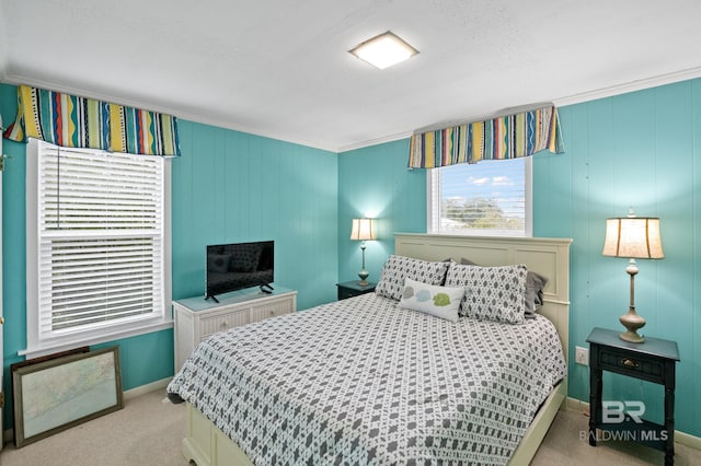 bedroom featuring light carpet, ornamental molding, and baseboards