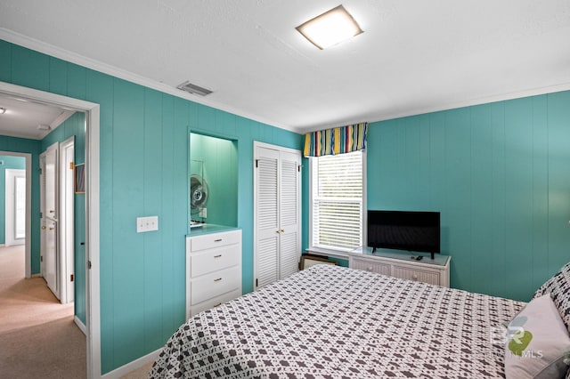 bedroom featuring light colored carpet, visible vents, baseboards, ornamental molding, and a closet