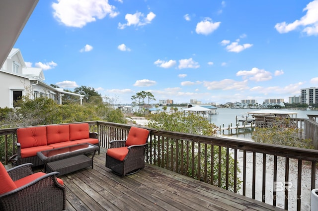 deck featuring a water view, outdoor lounge area, and a city view