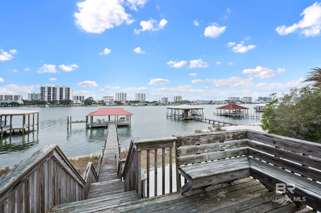 view of dock with a water view and a city view