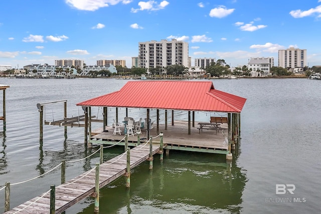 dock area featuring a view of city, a water view, and boat lift